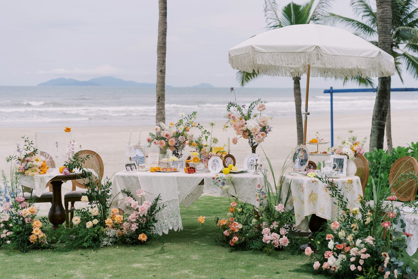 Elegant tables decorated for an outdoor event near the beach.