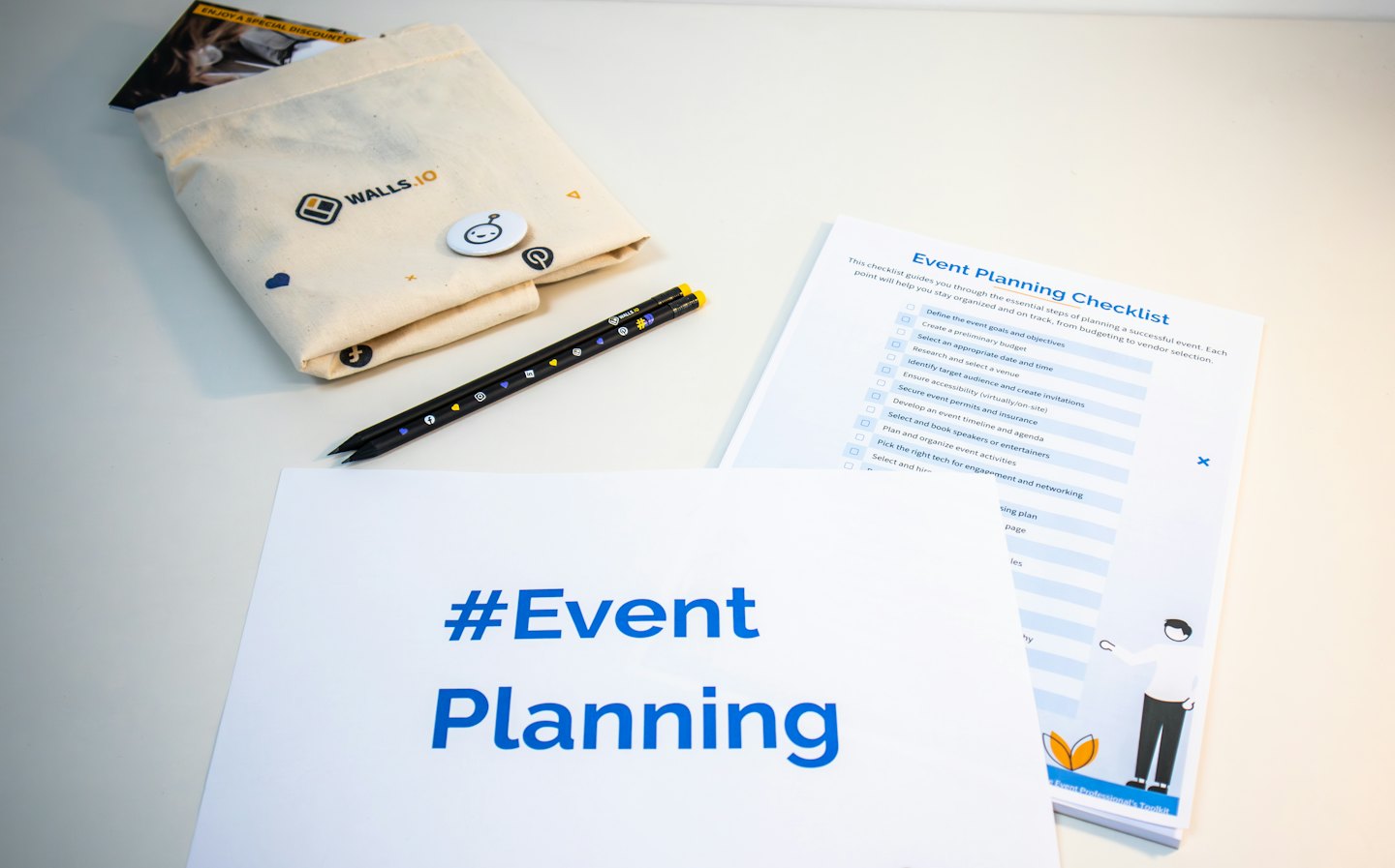 Event planning supplies laid out on a white table.